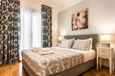 a bedroom with a bed and a window at Nicholas Point Apartments and Rooms in Athens
