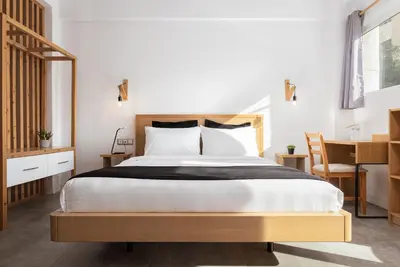 a bedroom with a large bed and a desk at Acropolis Cozy Living in Athens