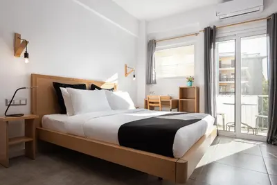 a bedroom with a bed and a large window at Acropolis Cozy Living in Athens