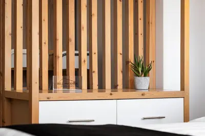 a wooden crib with a potted plant on top of it at Acropolis Cozy Living in Athens