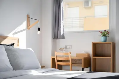 a bedroom with a bed and a desk and a chair at Acropolis Cozy Living in Athens