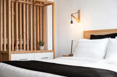 a bedroom with a bed with a wooden headboard at Acropolis Cozy Living in Athens