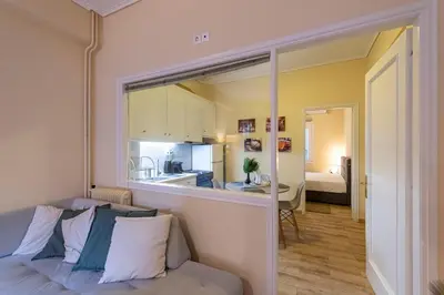 a living room with a bed and a kitchen at Athens Luxury House in Athens