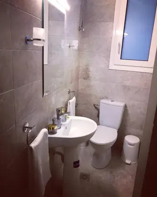 a bathroom with a white toilet and a sink at Athens Luxury House in Athens