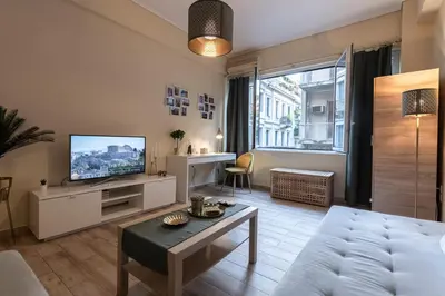a living room with a couch and a tv at Athens Luxury House in Athens