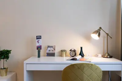 a white desk with a lamp and a chair at Athens Luxury House in Athens