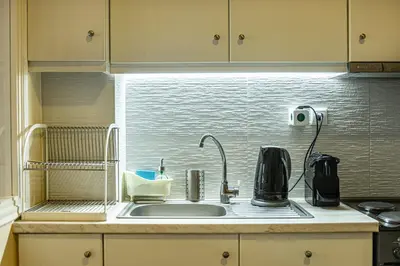 a kitchen sink with a coffee maker and a camera at Athens Luxury House in Athens