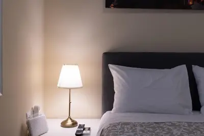 a bedroom with a bed with a lamp on a table at Athens Luxury House in Athens