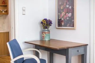 a table with a vase of flowers on top of it at The Athenian Apartment in Athens
