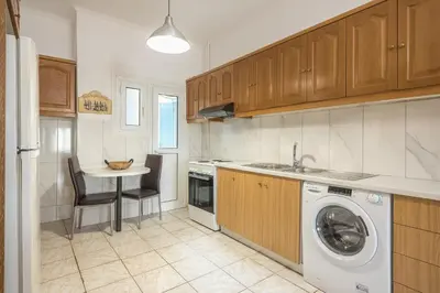 a kitchen with a washing machine and a sink at The Athenian Apartment in Athens