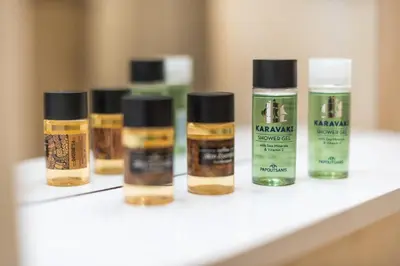 a row of four bottles of essential oils on a shelf at The Athenian Apartment in Athens