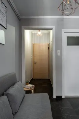 a living room with a couch and a door at Eleana Apartment By The Acropolis in Athens