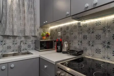 a kitchen with a sink and a stove top oven at Eleana Apartment By The Acropolis in Athens