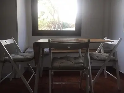 a table and two chairs in a room with a window at Villa Christina with private pool in Saronida, near stunning beaches, Athens airport & Sounio in Saronida