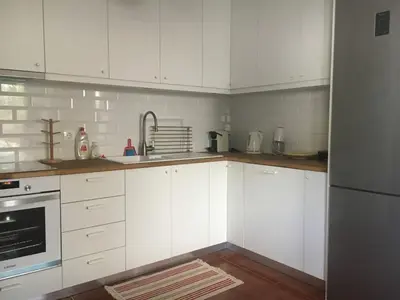 a kitchen with white cabinets and a sink at Villa Christina with private pool in Saronida, near stunning beaches, Athens airport & Sounio in Saronida