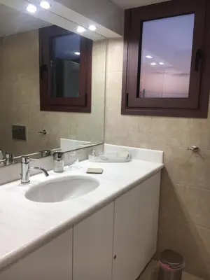 a bathroom with a white sink and a mirror at Villa Christina with private pool in Saronida, near stunning beaches, Athens airport & Sounio in Saronida