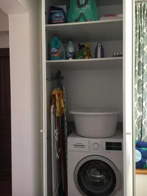 a washer and dryer sitting in a closet at Villa Christina with private pool in Saronida, near stunning beaches, Athens airport & Sounio in Saronida