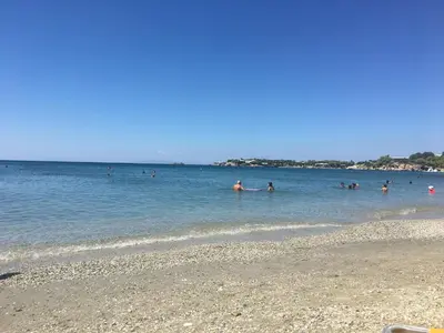 a group of people in the water at a beach at Villa Christina with private pool in Saronida, near stunning beaches, Athens airport & Sounio in Saronida