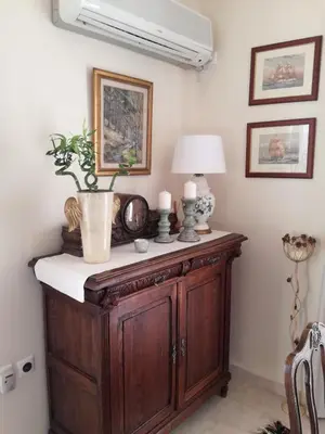a room with a table with a lamp and a plant on it at Maria's House in Athens
