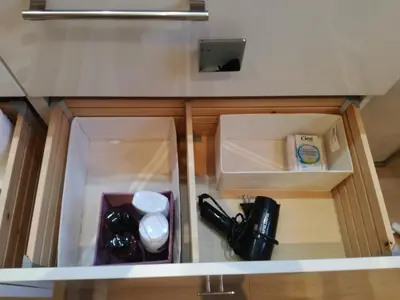 a cupboard with a box and a bottle of wine at Maria's House in Athens