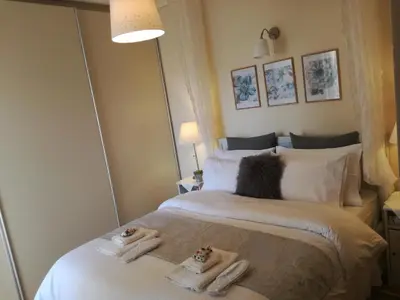 a bedroom with two beds with towels on them at Maria's House in Athens