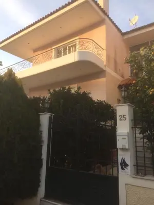 a house with a gate with the number on it at Maria's House in Athens