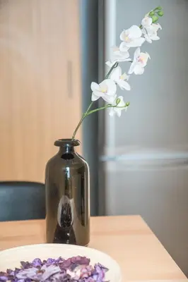 a vase with a flower in it on a table at Modern design apartment near Acropolis 2 in Athens