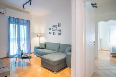 a living room with a couch and a table at Modern design apartment near Acropolis 2 in Athens