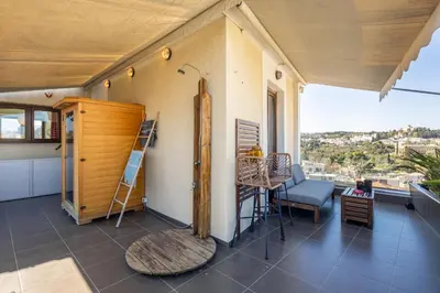 a room with a table and a chair and a window at The 1 and only Acropolis penthouse in Athens