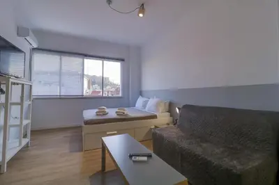 a living room with a couch and a bed at apartotel.acropolis.view in Athens