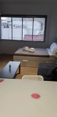 a room with a bed and a table and two windows at apartotel.acropolis.view in Athens