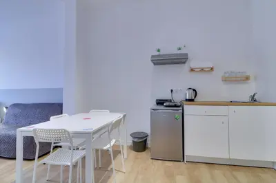 a small kitchen with a white table and chairs at apartotel.acropolis.view in Athens