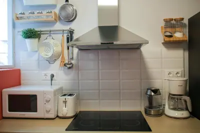 a kitchen with a counter top with a microwave at Spacious Central Flat☆3min to Metro☆AC|Netflix|PC in Athens