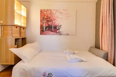 a bedroom with a bed with two towels on it at Spacious Central Flat☆3min to Metro☆AC|Netflix|PC in Athens