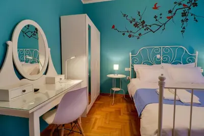 a bedroom with a bed with a desk and a mirror at Spacious Central Flat☆3min to Metro☆AC|Netflix|PC in Athens