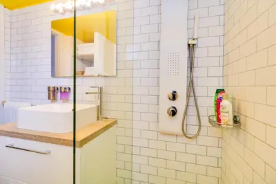 a bathroom with a sink and a shower at Spacious Central Flat☆3min to Metro☆AC|Netflix|PC in Athens