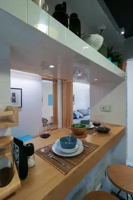 a kitchen with a table with plates and wine glasses at Superior Central Apt|3min to Metro|AC|Netflix|iMac in Athens