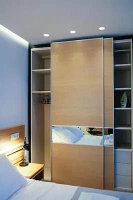 a large wooden partition in a bedroom with a bed at Superior Central Apt|3min to Metro|AC|Netflix|iMac in Athens