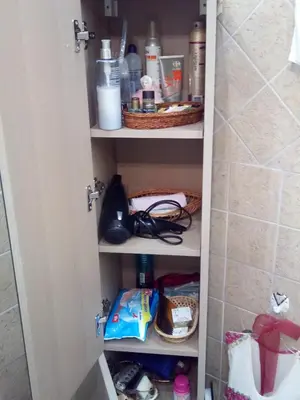 a cupboard in a bathroom with some items on it at Nana's philoxenia in Porto Rafti