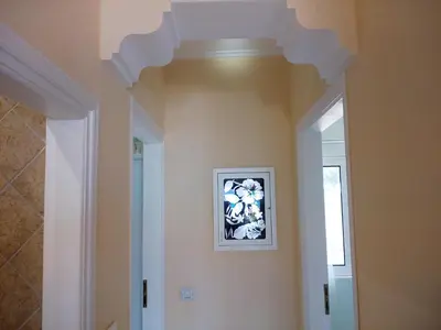 a hallway with a picture of flowers on the wall at Nana's philoxenia in Porto Rafti