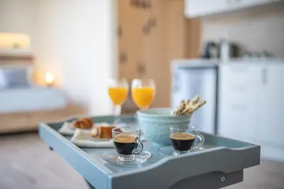 a tray with two cups of coffee and two glasses of orange juice at Ancient Agora Apartments in Athens