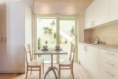 a kitchen with a table and chairs and a window at Ancient Agora Apartments in Athens