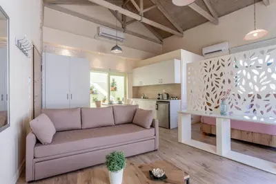 a living room with a couch and a kitchen at Ancient Agora Apartments in Athens