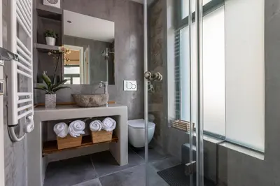 a bathroom with a shower and a toilet and a sink at Ancient Agora Apartments in Athens