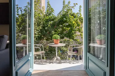 an open door to a patio with chairs and plants at Ancient Agora Apartments in Athens
