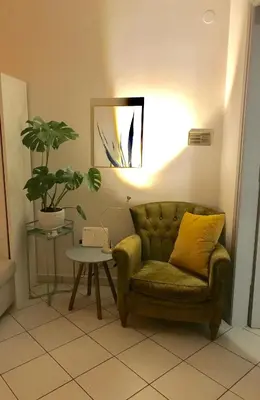 a living room with a couch and a table with a plant at Stefanias sunny Acropolis Studio on Drakou pedestrian in Athens