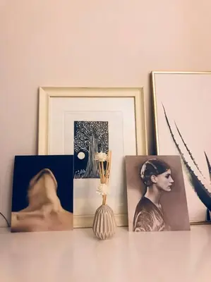 a table with pictures and a vase and a picture at Stefanias sunny Acropolis Studio on Drakou pedestrian in Athens