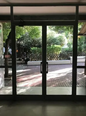 an open glass door with a view of a courtyard at Stefanias sunny Acropolis Studio on Drakou pedestrian in Athens