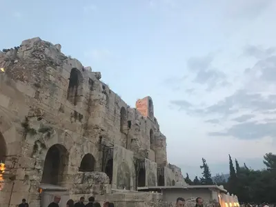 a group of people standing in front of a stone building at Stefanias sunny Acropolis Studio on Drakou pedestrian in Athens