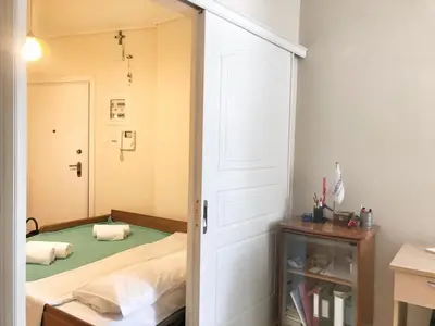 a bedroom with a bed and a door with a mirror at Seaview 2nd flr. apt. next to the beach, wifi,a/c,p/c media. in Anavissos